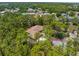 Overhead view of a house with mature trees and well-manicured lawn at 4960 Hidden Knob Trl, Spring Hill, FL 34609
