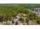 Expansive aerial view of home nestled within a lush green canopy at 4960 Hidden Knob Trl, Spring Hill, FL 34609