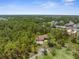 Overhead view of a single-Gathering home nestled among trees, showcasing a large lot at 4960 Hidden Knob Trl, Spring Hill, FL 34609