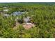 A high-angle aerial view of a secluded home and long driveway at 4960 Hidden Knob Trl, Spring Hill, FL 34609