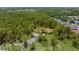 Expansive aerial view of home nestled within a lush green canopy at 4960 Hidden Knob Trl, Spring Hill, FL 34609