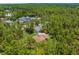 A high-angle aerial view of a secluded home and long driveway at 4960 Hidden Knob Trl, Spring Hill, FL 34609
