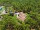Overhead shot of a home immersed in a dense forest, highlighting the secluded location at 4960 Hidden Knob Trl, Spring Hill, FL 34609