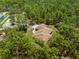 Aerial view of a secluded home surrounded by lush forest, offering privacy and tranquility at 4960 Hidden Knob Trl, Spring Hill, FL 34609