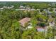 Overhead view of a house with mature trees and well-manicured lawn at 4960 Hidden Knob Trl, Spring Hill, FL 34609