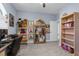 Cozy bedroom area with ample display shelving and a large window at 4960 Hidden Knob Trl, Spring Hill, FL 34609