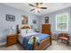 Cozy bedroom featuring a wooden bed frame, soft blue walls, and a bright window for natural light at 4960 Hidden Knob Trl, Spring Hill, FL 34609