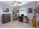 Bright bedroom showcasing decor, shelving, and a well-lit desk area by the window at 4960 Hidden Knob Trl, Spring Hill, FL 34609