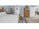 Comfortable bedroom with light walls, offering a glimpse into an attached bathroom, and additional furnishings at 4960 Hidden Knob Trl, Spring Hill, FL 34609