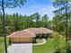 Charming home featuring a three-car garage and landscaped front yard at 4960 Hidden Knob Trl, Spring Hill, FL 34609