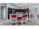 Stylish kitchen with dark wood cabinets, stainless appliances, breakfast bar, and seating for casual dining at 4960 Hidden Knob Trl, Spring Hill, FL 34609