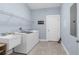 Well-lit laundry room featuring a utility sink, washer and dryer, and wire shelving for optimal organization at 4960 Hidden Knob Trl, Spring Hill, FL 34609