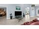 Open concept living room featuring high ceilings and neutral colors with a view of the office and bedroom at 4960 Hidden Knob Trl, Spring Hill, FL 34609