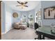 Inviting home office space with arched windows, desk, and comfortable seating area with neutral decor at 4960 Hidden Knob Trl, Spring Hill, FL 34609