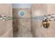 Detailed shower with decorative tilework and a small octagon window allowing natural light at 4960 Hidden Knob Trl, Spring Hill, FL 34609