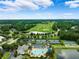 Stunning aerial view of golf course, tennis courts, community pool and meticulously maintained landscaping at 5005 Southern Valley Loop, Brooksville, FL 34601