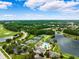 Gorgeous aerial view of community pool, tennis courts, golf course, and lush landscaping on a sunny day at 5005 Southern Valley Loop, Brooksville, FL 34601