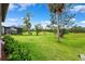 Expansive green backyard with views of mature trees and a screened-in enclosure at 5005 Southern Valley Loop, Brooksville, FL 34601