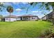 Spacious backyard featuring lush lawn and inviting covered patio at 5005 Southern Valley Loop, Brooksville, FL 34601