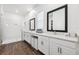 Modern bathroom features dual sinks, white cabinetry, and a glass-enclosed shower for a spa-like experience at 5005 Southern Valley Loop, Brooksville, FL 34601