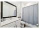 Bright bathroom features white vanity with quartz counters and a shower with modern fixtures at 5005 Southern Valley Loop, Brooksville, FL 34601
