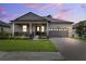 Charming single-story home with a covered front porch, manicured lawn, and two-car garage at 5005 Southern Valley Loop, Brooksville, FL 34601