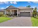Charming single-story home with a covered front porch, manicured lawn, and two-car garage at 5005 Southern Valley Loop, Brooksville, FL 34601