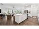 Open-concept kitchen island with stainless steel appliances, seamlessly connecting to the adjacent living area at 5005 Southern Valley Loop, Brooksville, FL 34601