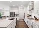 Bright kitchen with stainless steel appliances and countertops, and a seamless flow to the dining area at 5005 Southern Valley Loop, Brooksville, FL 34601