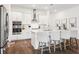 Bright kitchen with white cabinetry, stainless steel appliances, central island, and stylish bar stool seating at 5005 Southern Valley Loop, Brooksville, FL 34601
