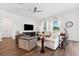 Bright living room with modern furnishings, wood-look tile flooring, and ample natural light at 5005 Southern Valley Loop, Brooksville, FL 34601
