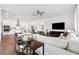 Open-concept living room with a modern kitchen, sleek furnishings, and wood-look tile flooring at 5005 Southern Valley Loop, Brooksville, FL 34601