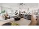 Spacious living room with wood floors, modern furnishings, an open layout, and seamless kitchen access at 5005 Southern Valley Loop, Brooksville, FL 34601
