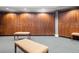 Well-appointed locker room with wooden lockers, padded benches, and a patterned carpet at 5005 Southern Valley Loop, Brooksville, FL 34601