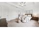 Bright main bedroom featuring a ceiling fan, plush carpeting, and a coordinated furniture set at 5005 Southern Valley Loop, Brooksville, FL 34601
