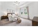 Serene main bedroom boasts a tray ceiling, plush carpeting, and ample natural light from the windows at 5005 Southern Valley Loop, Brooksville, FL 34601