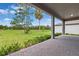 Covered patio with brick pavers overlooks green space and mature trees at 5005 Southern Valley Loop, Brooksville, FL 34601