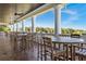 Covered porch with multiple tables and chairs, offering picturesque views of surrounding nature at 5005 Southern Valley Loop, Brooksville, FL 34601