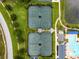 Overhead shot of community tennis and pickleball courts, pool, and manicured walking paths at 5005 Southern Valley Loop, Brooksville, FL 34601