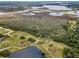 Scenic aerial shot of lakes, winding trails and green spaces in the community at 5132 Flora Ave, Holiday, FL 34690