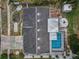 Bird's eye view displays roof, pool area, shed, fire pit, and yard at 5132 Flora Ave, Holiday, FL 34690