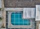 Overhead view of the screened-in pool showcases the pool's layout and surroundings at 5132 Flora Ave, Holiday, FL 34690