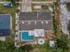 Aerial view showcases the home's layout, pool, fire pit, and landscaped yard at 5132 Flora Ave, Holiday, FL 34690