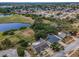 Expansive aerial view of the property showcasing pool, landscaping, and neighborhood amenities at 5132 Flora Ave, Holiday, FL 34690