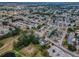 Wide aerial view of the neighborhood, homes, and manicured streets from above at 5132 Flora Ave, Holiday, FL 34690