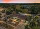 Stunning aerial view of property backing up to green space and waterway with a private screened-in pool at 5132 Flora Ave, Holiday, FL 34690