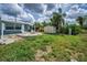 Landscaped backyard with fire pit, shed, and lush greenery offers a relaxing outdoor space at 5132 Flora Ave, Holiday, FL 34690