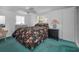 Comfortable bedroom with a floral bedspread, dresser, and ample natural light at 5132 Flora Ave, Holiday, FL 34690