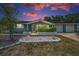 Charming single-story home with mature landscaping, manicured flowerbeds, and an attached two-car garage at 5132 Flora Ave, Holiday, FL 34690