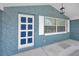 Eye-catching front porch with an ornate, colorful front door and well maintained exterior at 5132 Flora Ave, Holiday, FL 34690